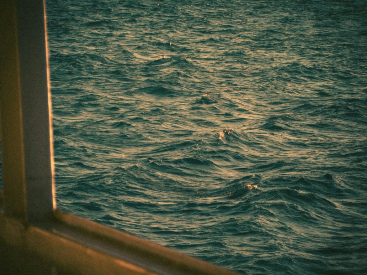 A view outside of the window towards the open sea representing that feeling of floating away and being disconnected with yourself.